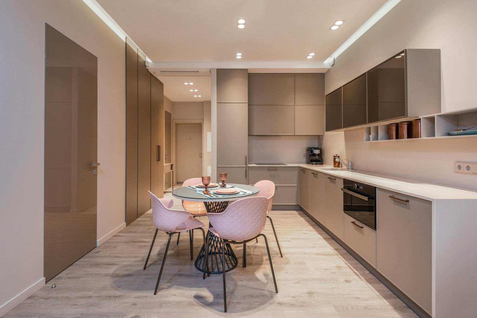 Sleek modern kitchen interior featuring minimalist design and dining setup.